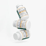 Three white supplement bottles labeled AgeCore NAD+ are arranged in a floating stack on a clean white background.