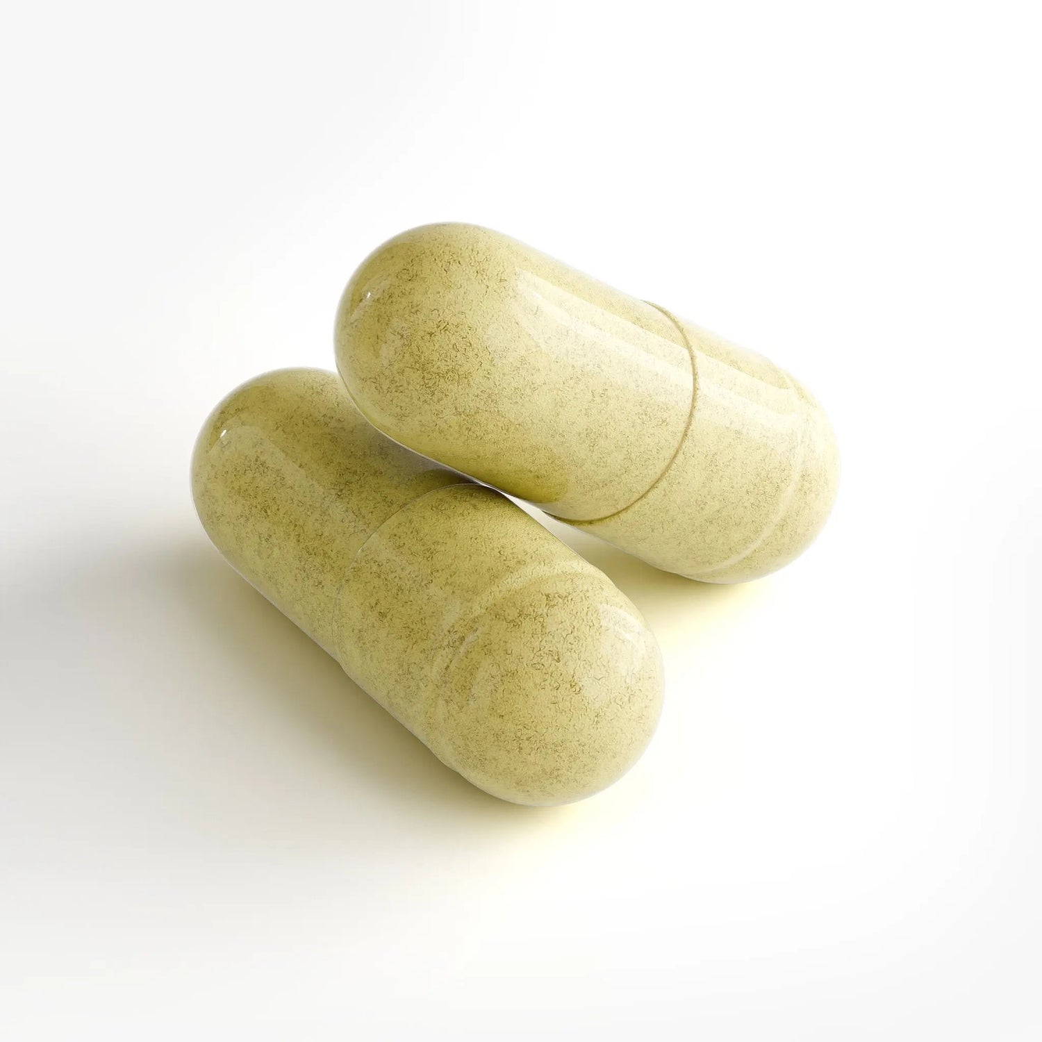 Two green capsules on a white background