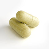 Two green capsules on a white background