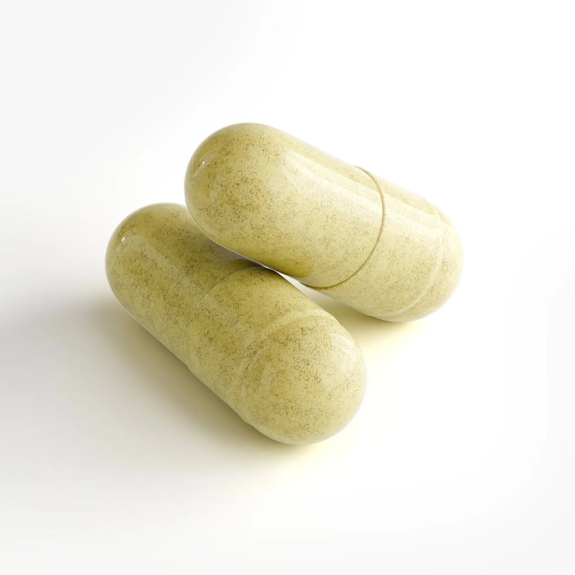 Two green capsules on a white background