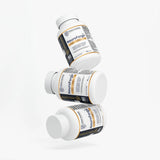 Three white IDRAK Pharma NeuroForge supplement bottles arranged in a floating diagonal stack on a clean white background.