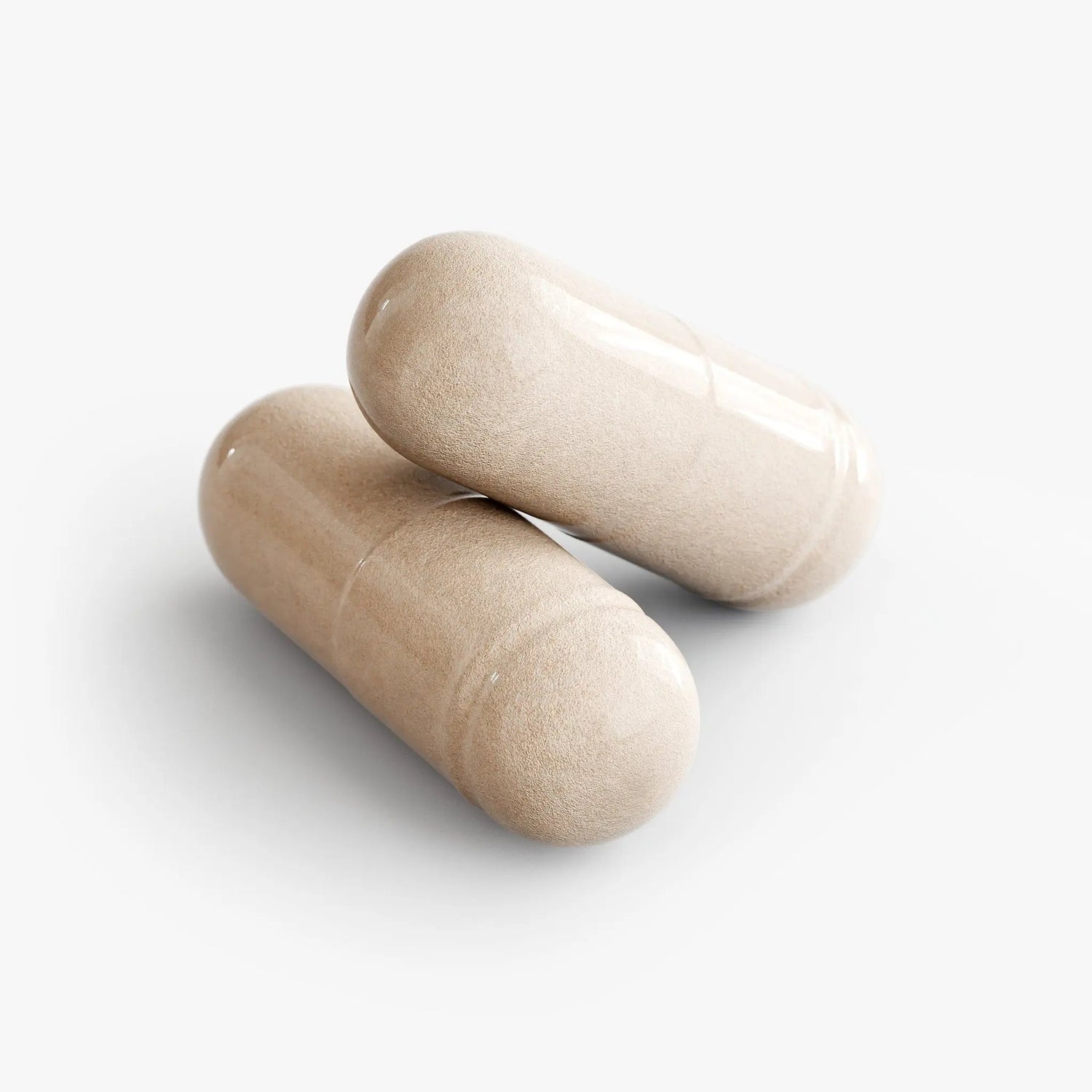 Two beige capsules on a white background