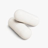 Close-up of two Rest Atlas Magnesium Glycinate capsules