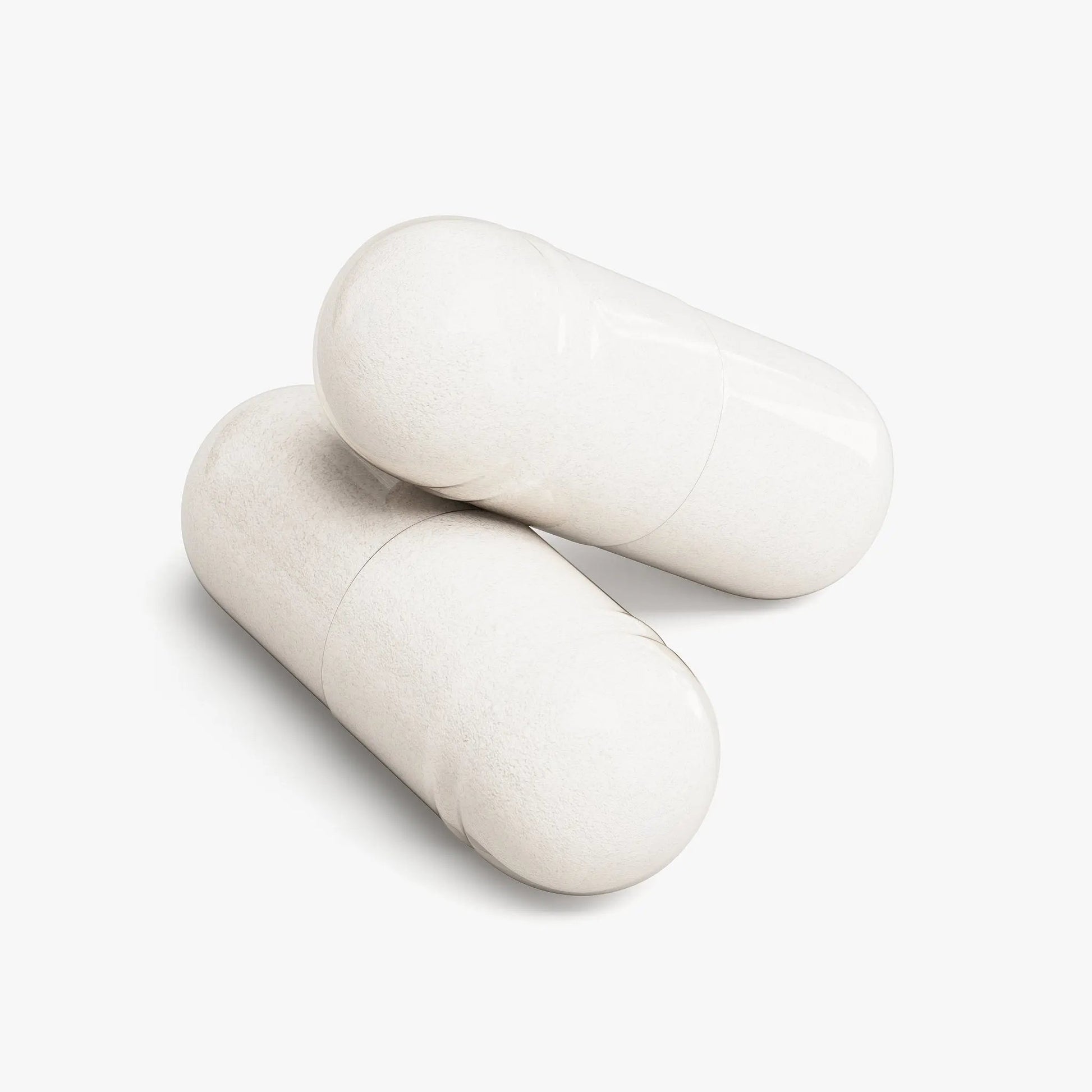 Close-up of two Rest Atlas Magnesium Glycinate capsules